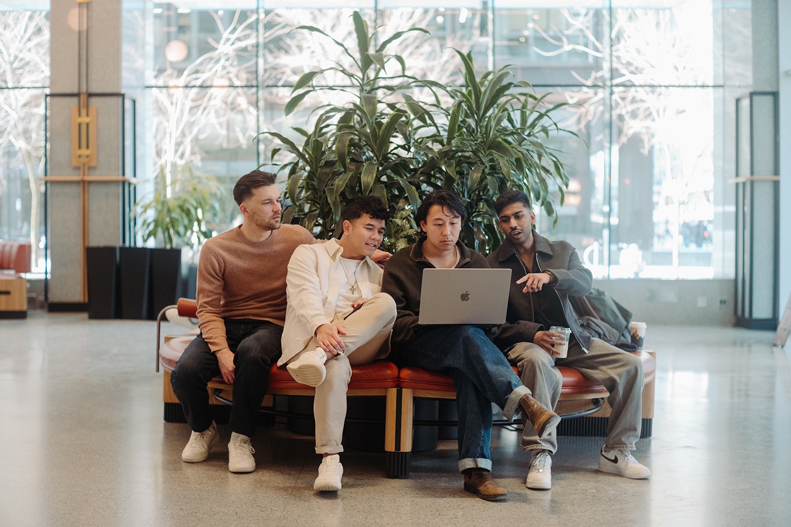 hyperlocal's four founders — Stephen Joel, Joel Vandervalk, Valiant Chan, and Hadi Ekaputra — in a downtown Vancouver lobby